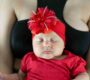 closeup face beautiful newborn latina baby sleeping her mothers chest dressed red 1 90x80